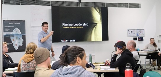 Instructor infront of class with students